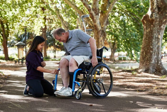 Advanced Occupational Therapist explaining how to use a powered assisted wheelchair.