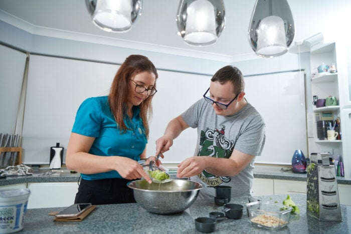 A customer and therapist cook together