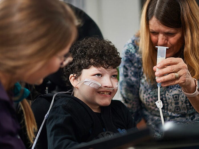 A young boy being PEG fed