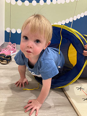 A young boy going through a play tunnel