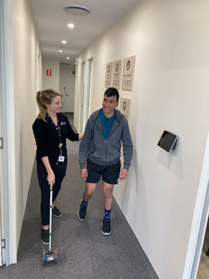Katherine and a young man completing a walking test