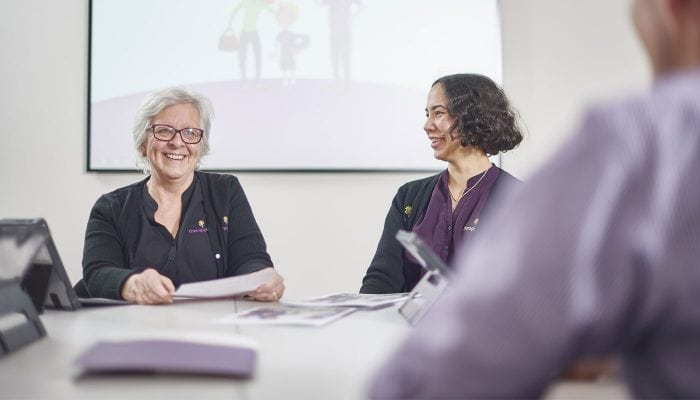Two Therapy Focus employees sitting at a table in training