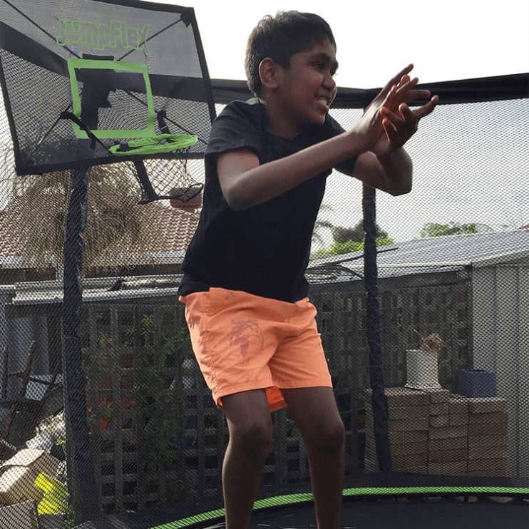 Aboriginal boy Zahmahn Jack jumping on a trampoline