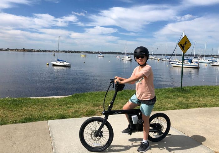 Lucas on his electric bike by the river