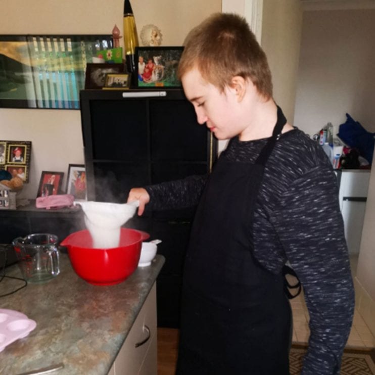 A boy sifting flour