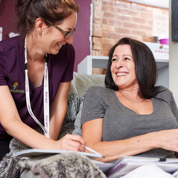 Therapist smiling at customer at home