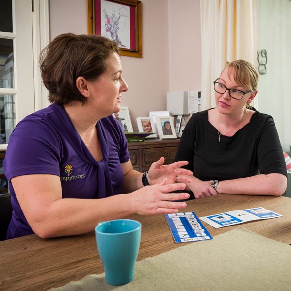 Psychologist talks with woman customer at dining table