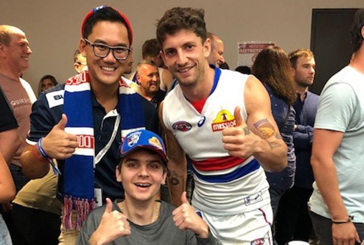 Two men with football player Tom Liberatore