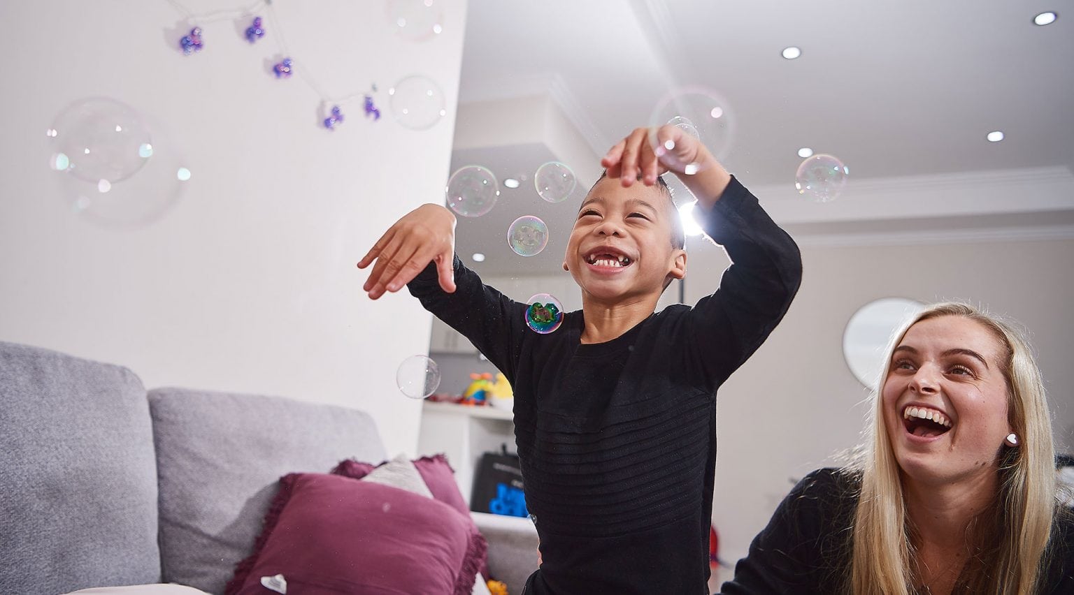 A boy playing with bubbles