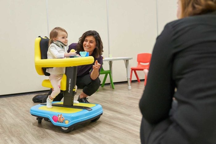 Olivia using the Mini Explorer with Laura encouraging her