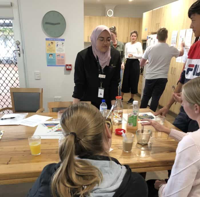 Zahraa supervises support workers at Eucalypt Home as they measure fluid thickness.