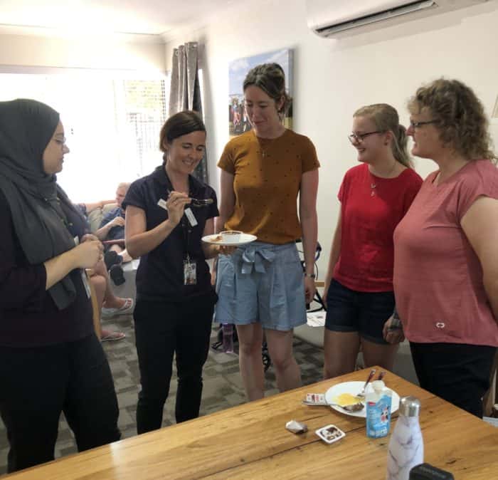 Kim stands with support workers from Eucalypt Home as she explains puree testing.