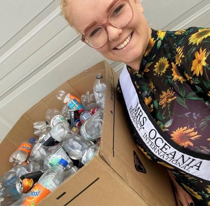 Emma smiling holding a box of containers