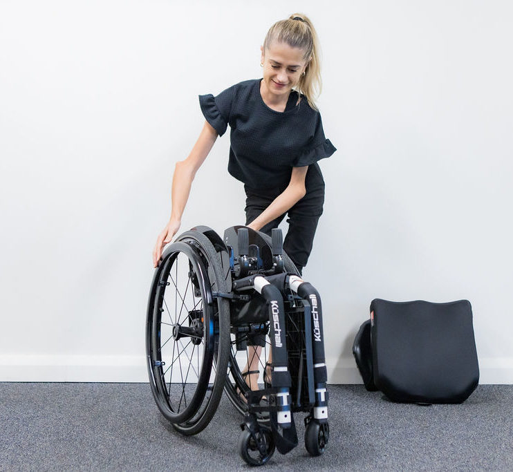 A customer folds away her wheelchair.