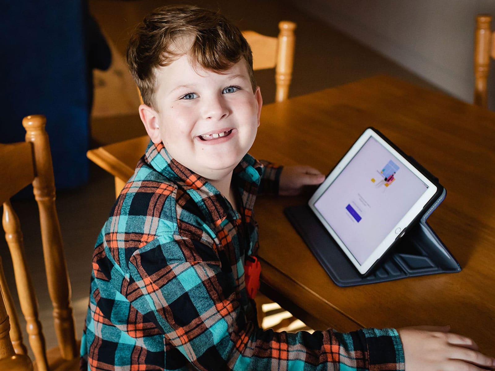 Young male customer smiling with tablet in background