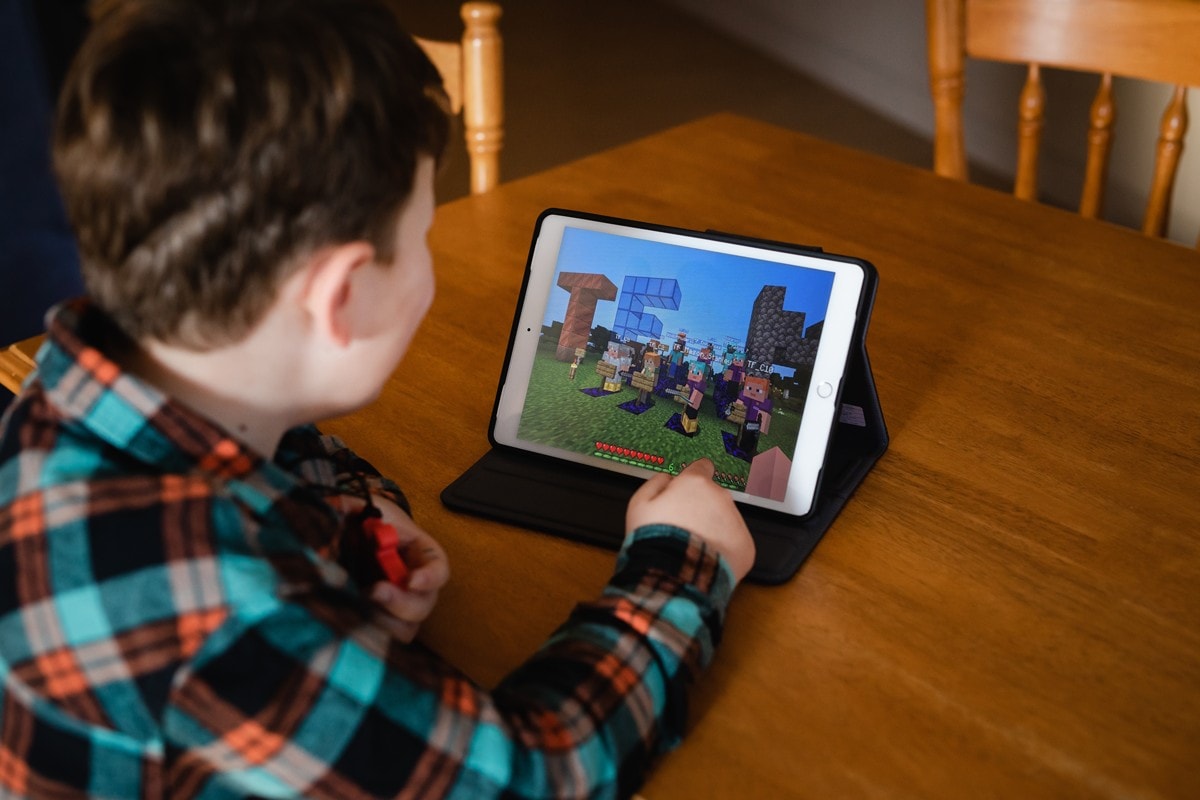 Customer engaging in Minecraft on iPad