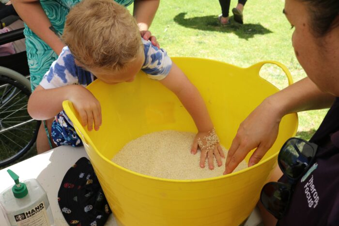 A customer plays in a sensory tub. 