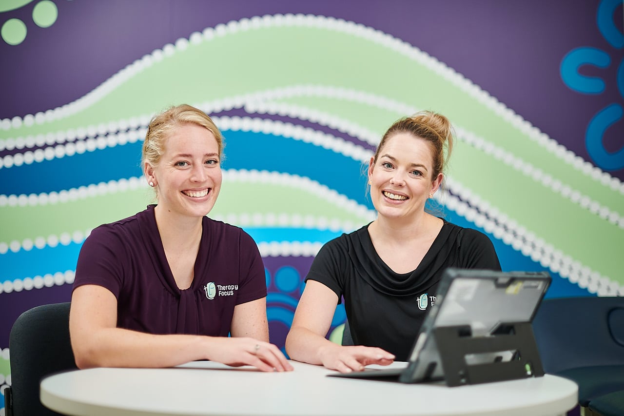 Two therapists smiling