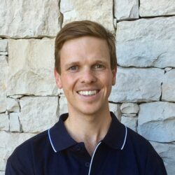 Headshot of Matthew Felton. He wears a dark polo top and has dark blonde hair.