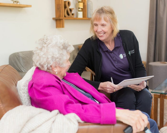 A Therapy Focus clinician smiling at an elderly woman