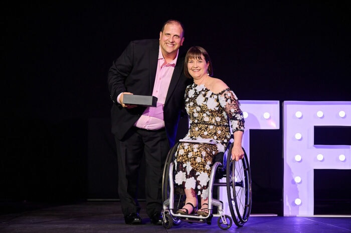 Jordan Palk accepting his award from Julianne Adams