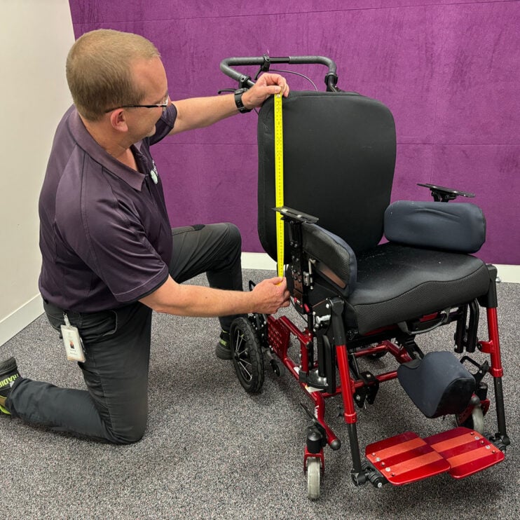 Richard measuring a wheelchair