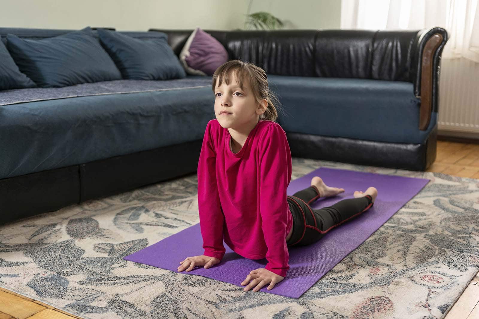 Young girl practising yoga at home