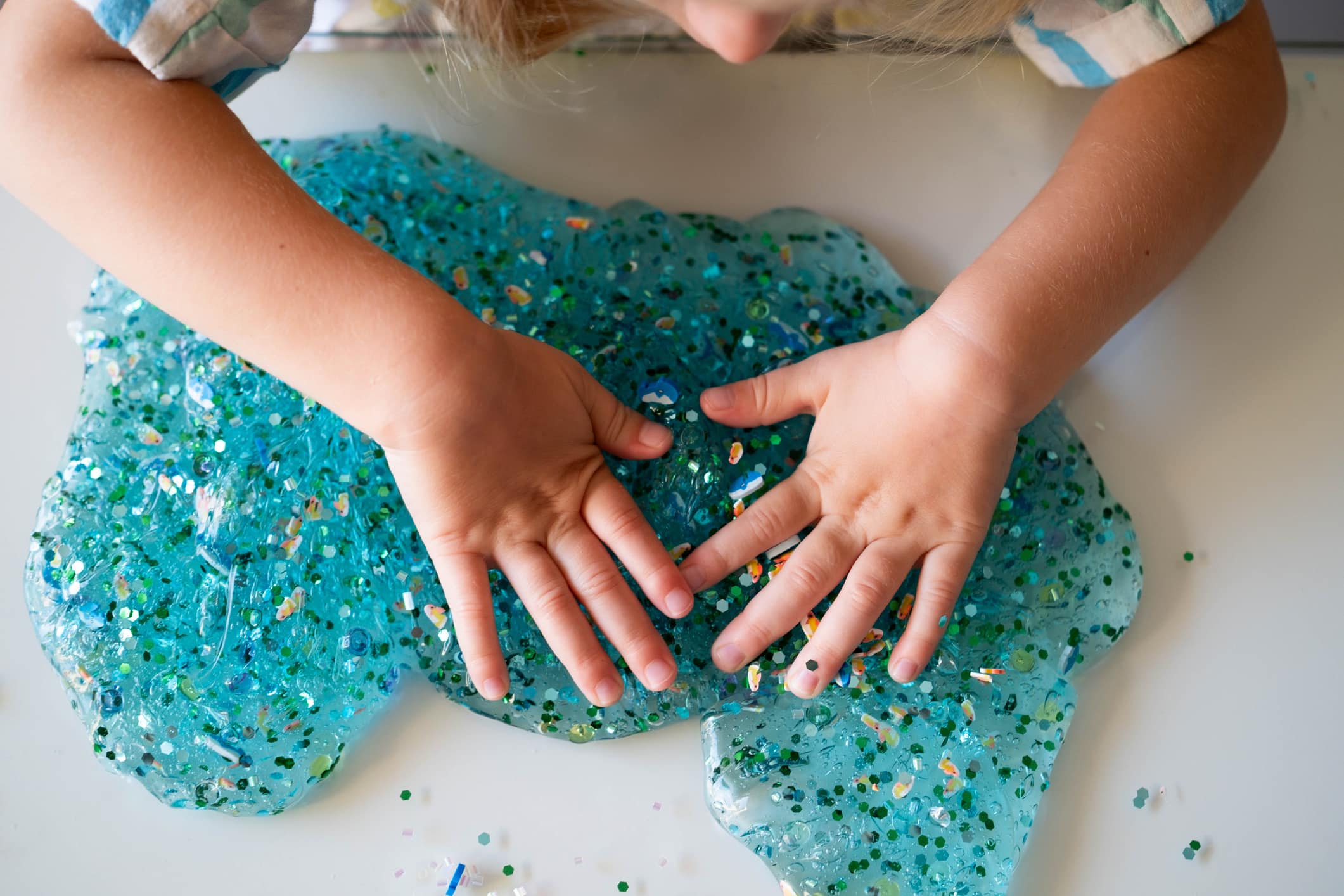 A child's hands in slime