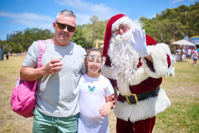 A man and girl with Santa
