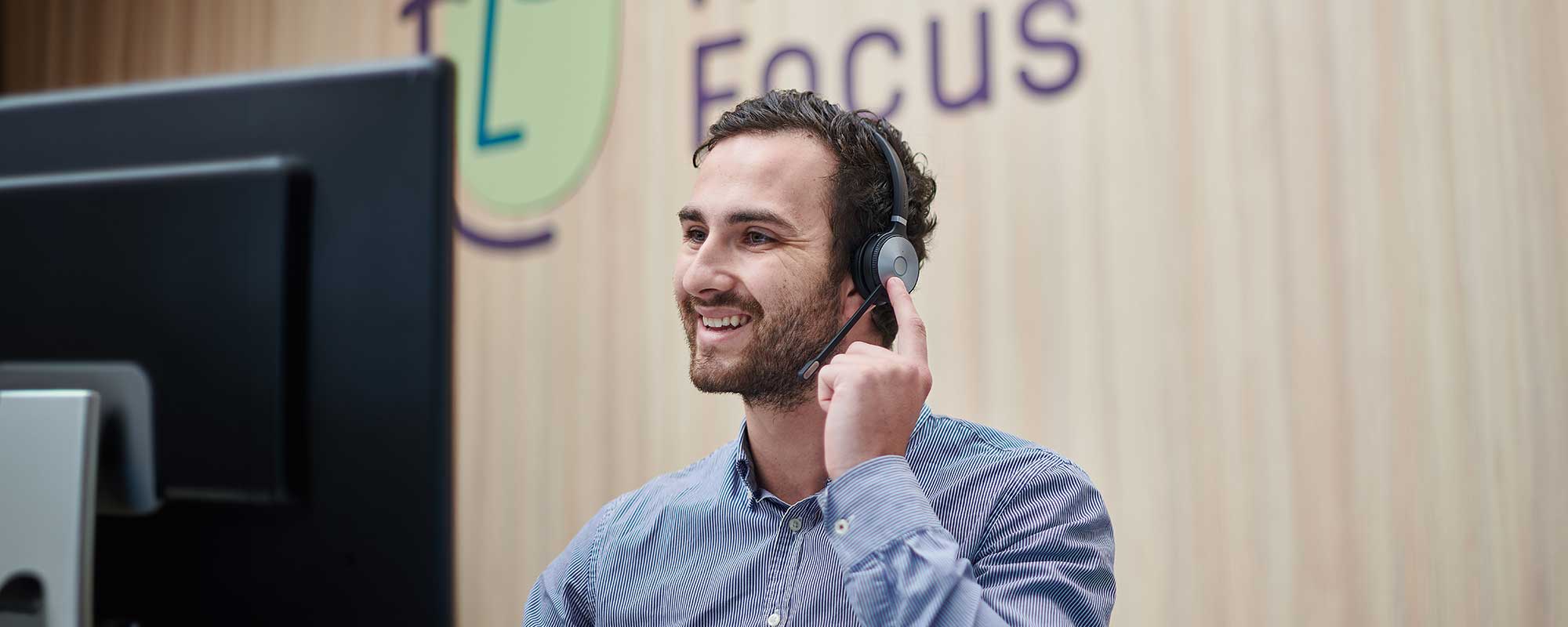 A man taking a call with a headset