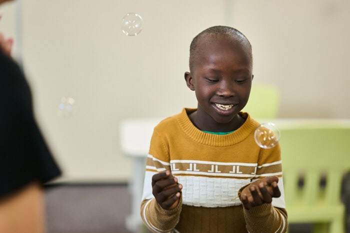 Young boy playing with bubbles