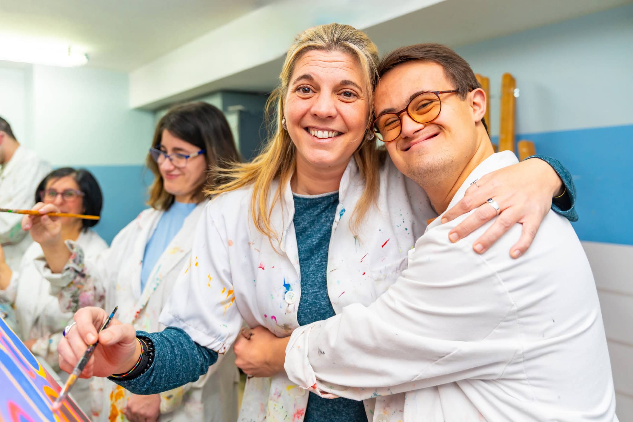 Friends painting and smiling at camera