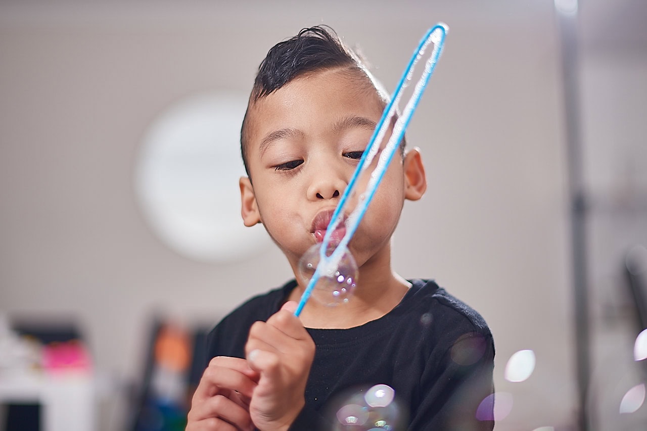 Boy blowing bubbles