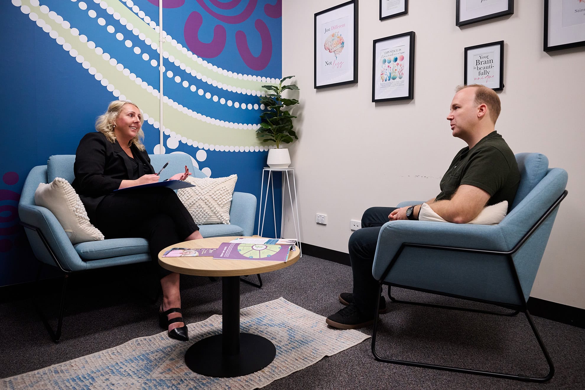 Female therapist smiles at customer during a session